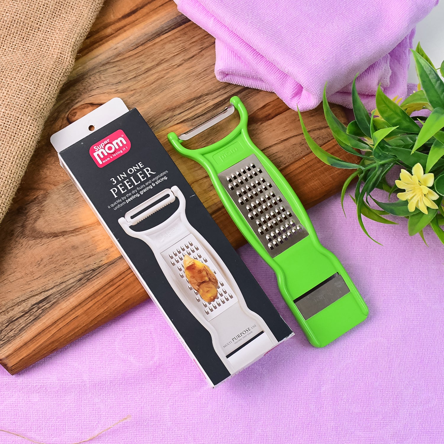 Wukusy Supermom 3-in-1 stainless steel vegetable and fruit peeler with ergonomic handle for kitchen prep.