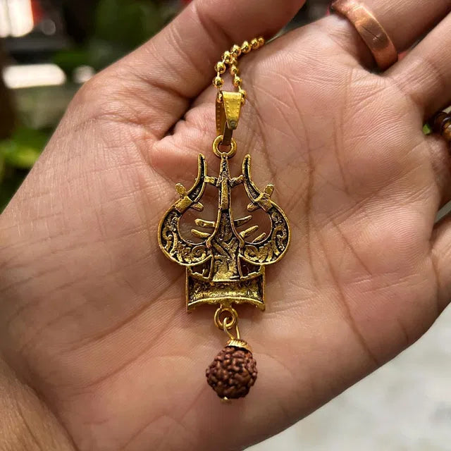 Spiritual necklace featuring Shiva Trishul and damaru, a traditional Pooja article with intricate design and religious symbolism.