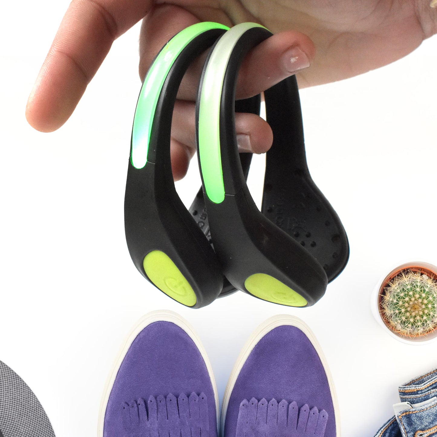 Pair of Wukusy LED shoes clip lights with bright, colorful illumination for sneakers or footwear, shown attached to shoes.