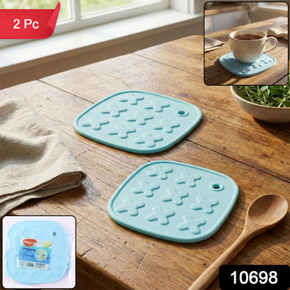 Wukusy heat resistant multipurpose cup coaster and hot pot pad set with two black silicone pads on a wooden table.