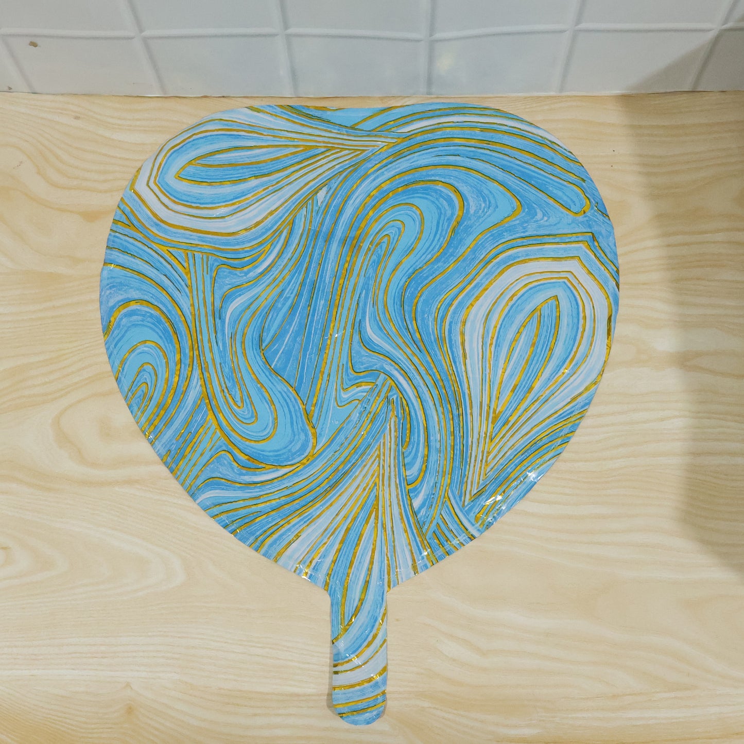 Blue marble heart foil party balloon by Wukusy, featuring a shiny blue and white marble pattern with a heart shape.