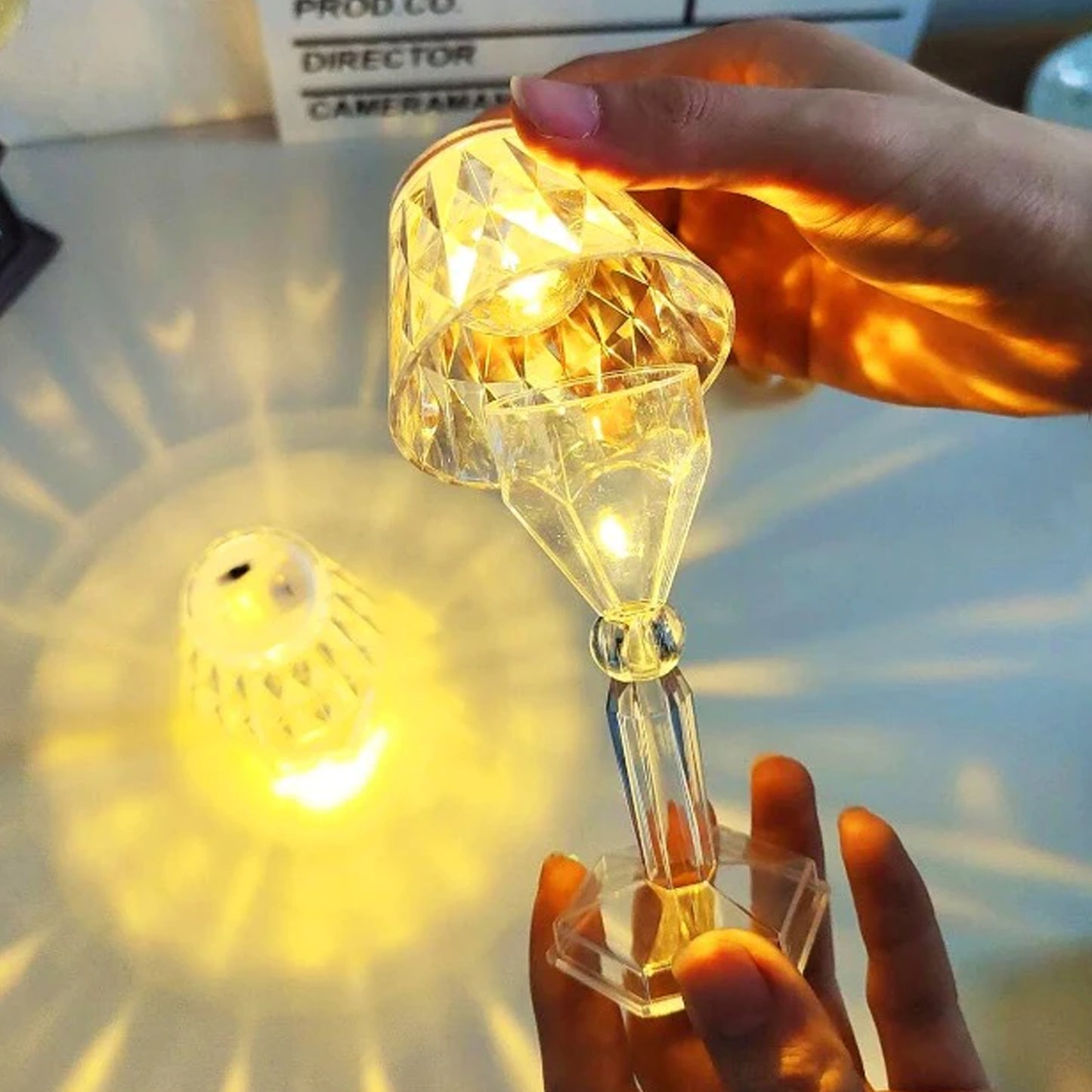 Wukusy 6610 2-in-1 transparent mini crystal table lamp with reflection light, showcasing its sleek design and glowing crystal accents.