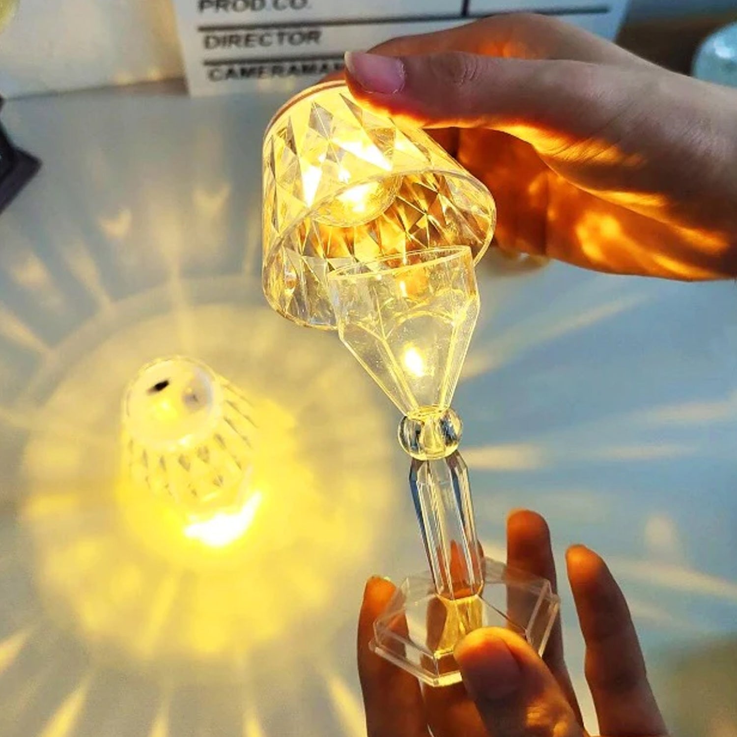 Wukusy 6610 2-in-1 transparent mini crystal table lamp with reflection light, showcasing its sleek design and glowing crystal accents.