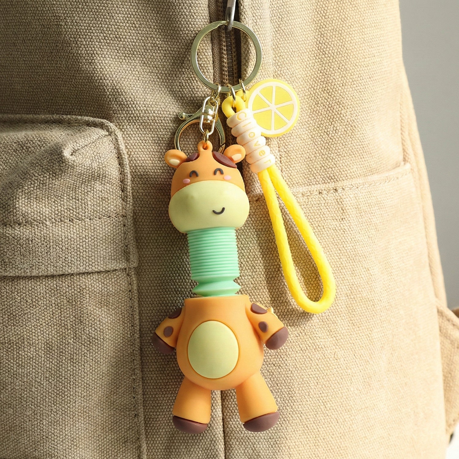 Wukusy cute giraffe cartoon keychain featuring a cheerful giraffe with large eyes and a small tail on a keyring.