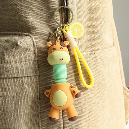 Wukusy cute giraffe cartoon keychain featuring a cheerful giraffe with large eyes and a small tail on a keyring.