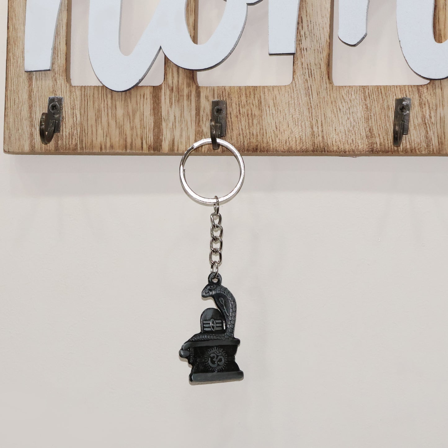 Silver Shivling keychain with snake design, crafted by Wukusy, featuring detailed metallic finish and compact size.