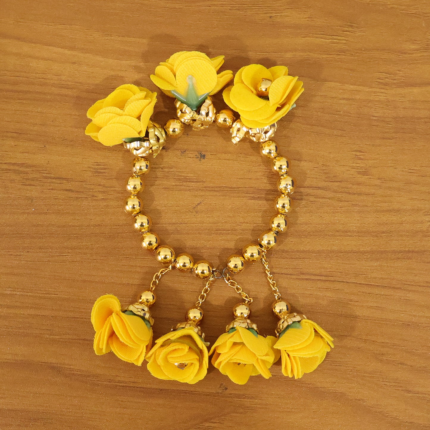 Traditional Pooja wrist ornament Haldi Kada bracelet by Wukusy, featuring gold-toned design with intricate detailing.