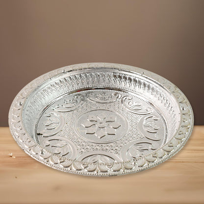 Traditional silver finish plastic pooja thali with intricate designs, ideal for religious rituals and home prayer ceremonies.