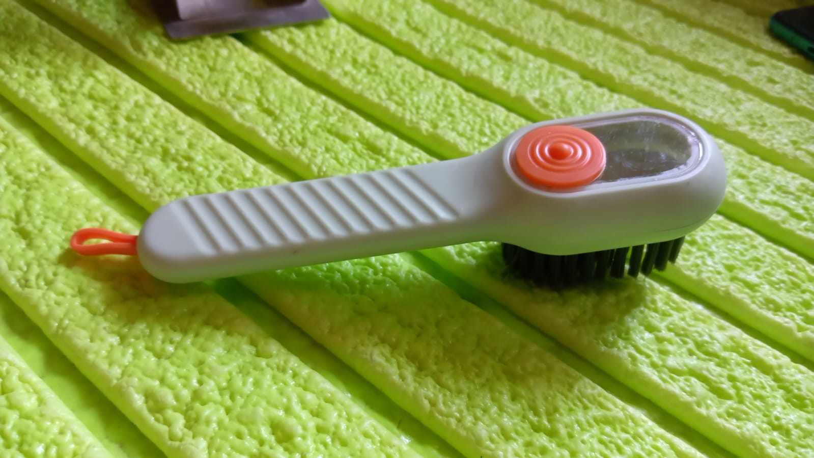 Wukusy multifunctional scrubbing brush with liquid soap dispenser, handle, and shoe cleaning brush for home cleaning tasks.