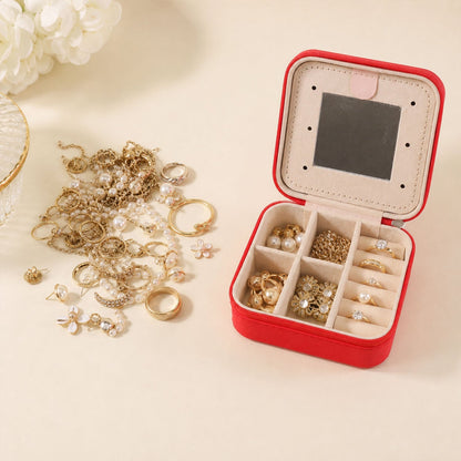 Wukusy mini jewelry organizer box with mirror, designed for rings and earrings, featuring a compact, clear plastic case with a mirror inside.