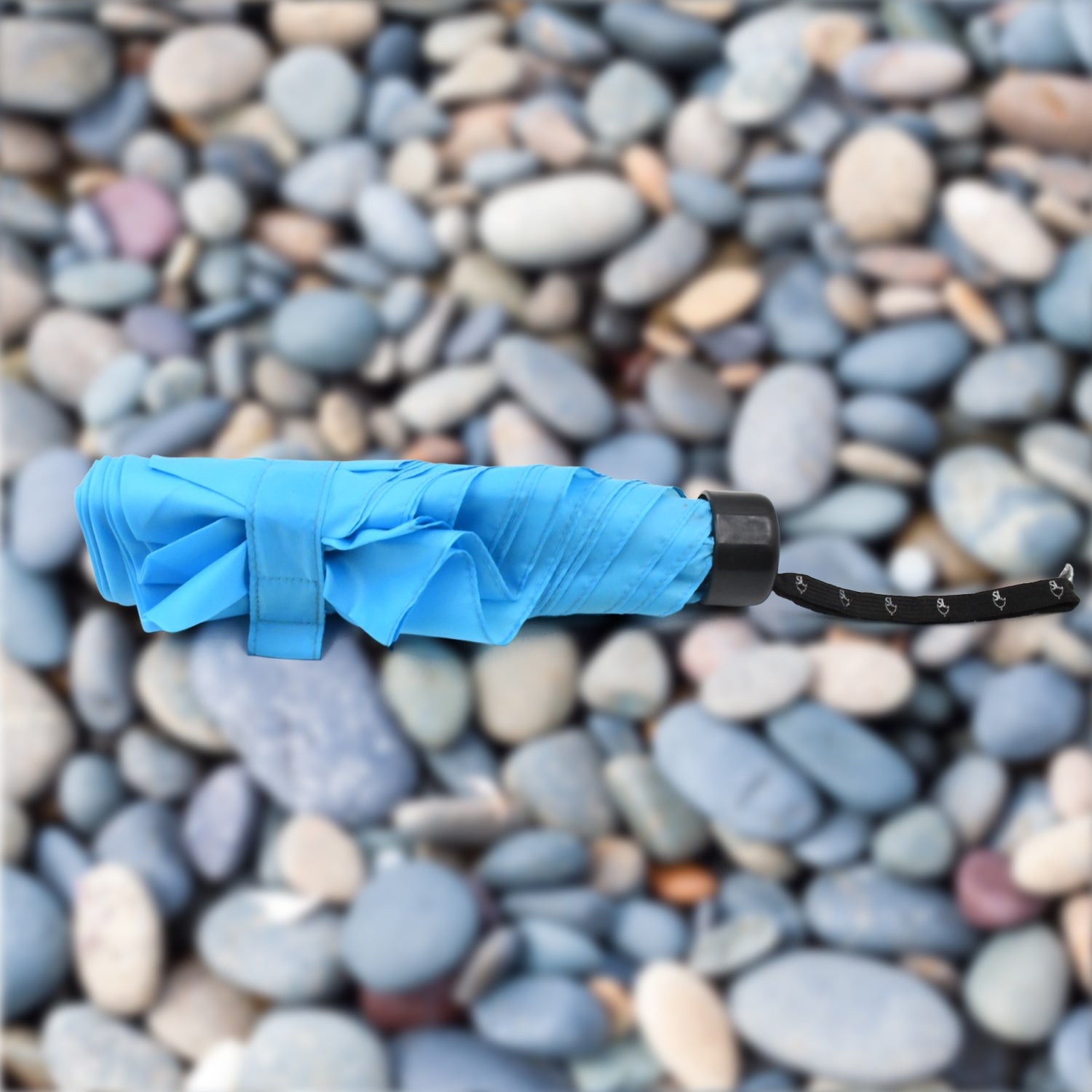 Foldable Wukusy umbrella with colorful design, providing UV protection and rain shielding for children and travel use.