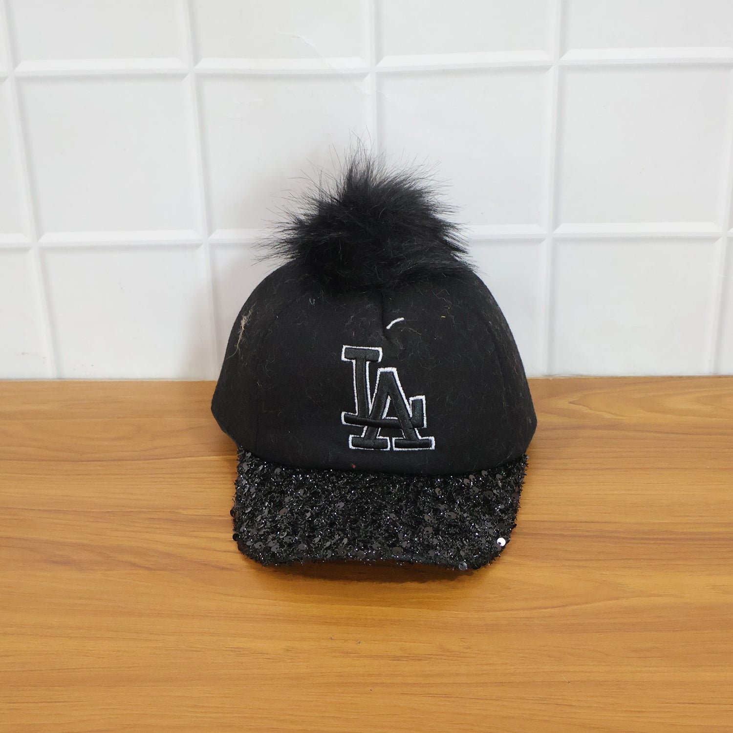 Wukusy stylish embroidered logo baseball cap with adjustable strap, black fabric featuring colorful embroidered design.
