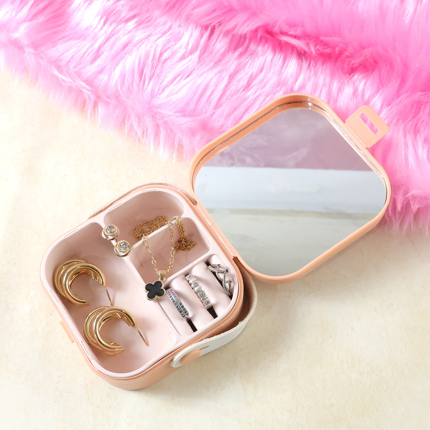 Wukusy portable mini jewelry storage box with compartments for rings, earrings, and small accessories on a white background.