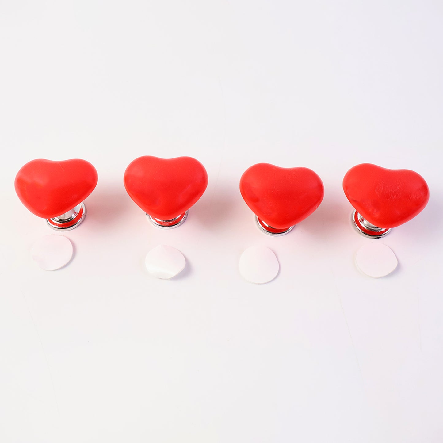 Set of four Wukusy heart-shaped cabinet door handle and drawer pulls with press button design for home improvement projects.