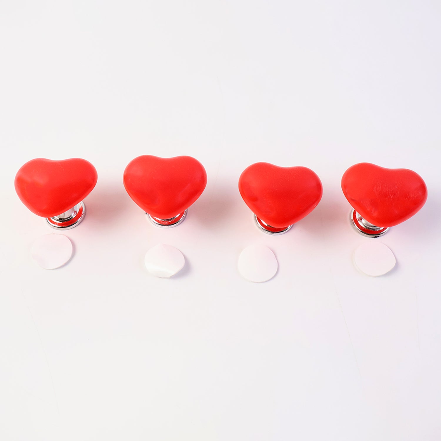 Set of four Wukusy heart-shaped cabinet door handle and drawer pulls with press button design for home improvement projects.
