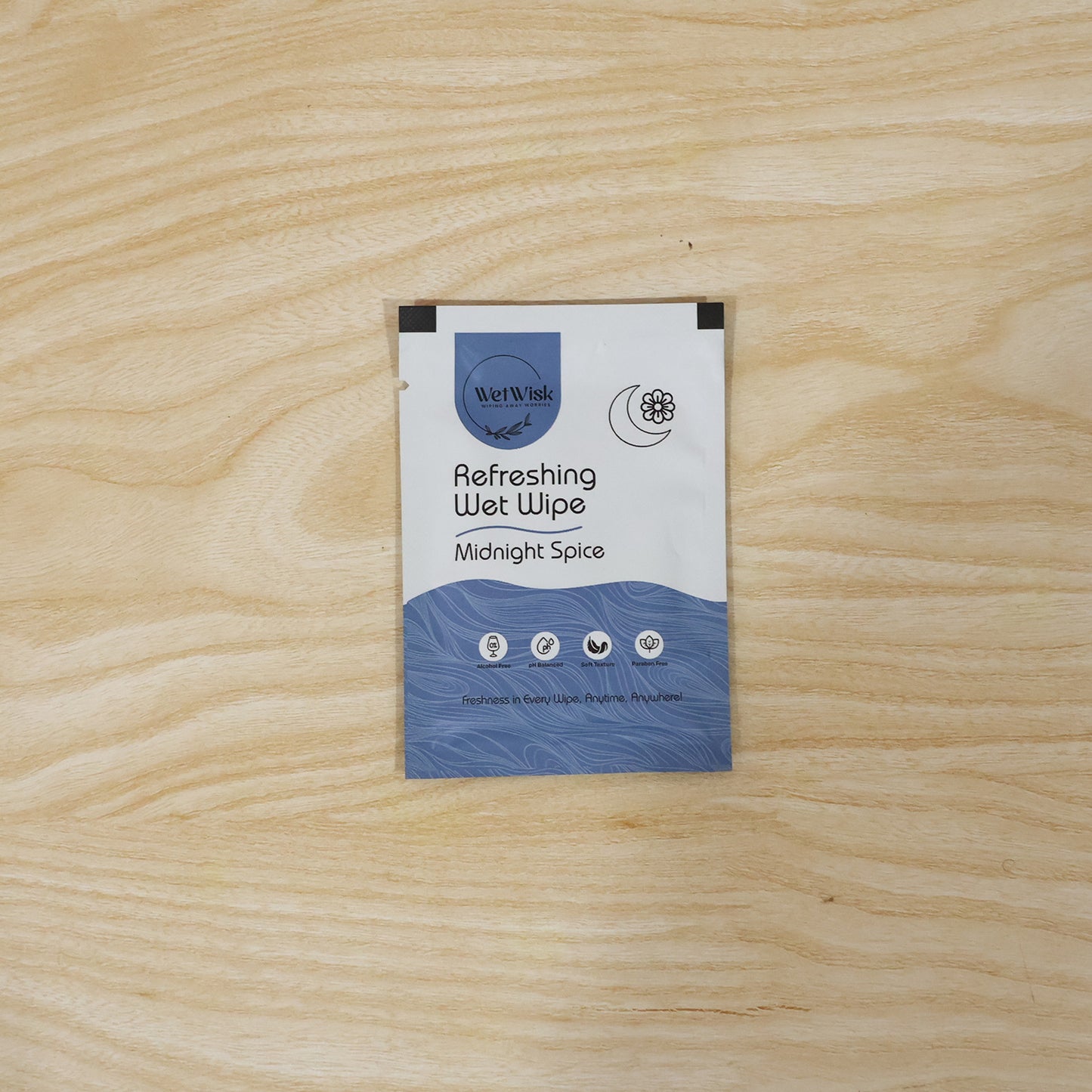 Wukusy Midnight Spice refreshing wet wipes for face, body, and hands, shown in a single packaged wipe with vibrant midnight spice design.