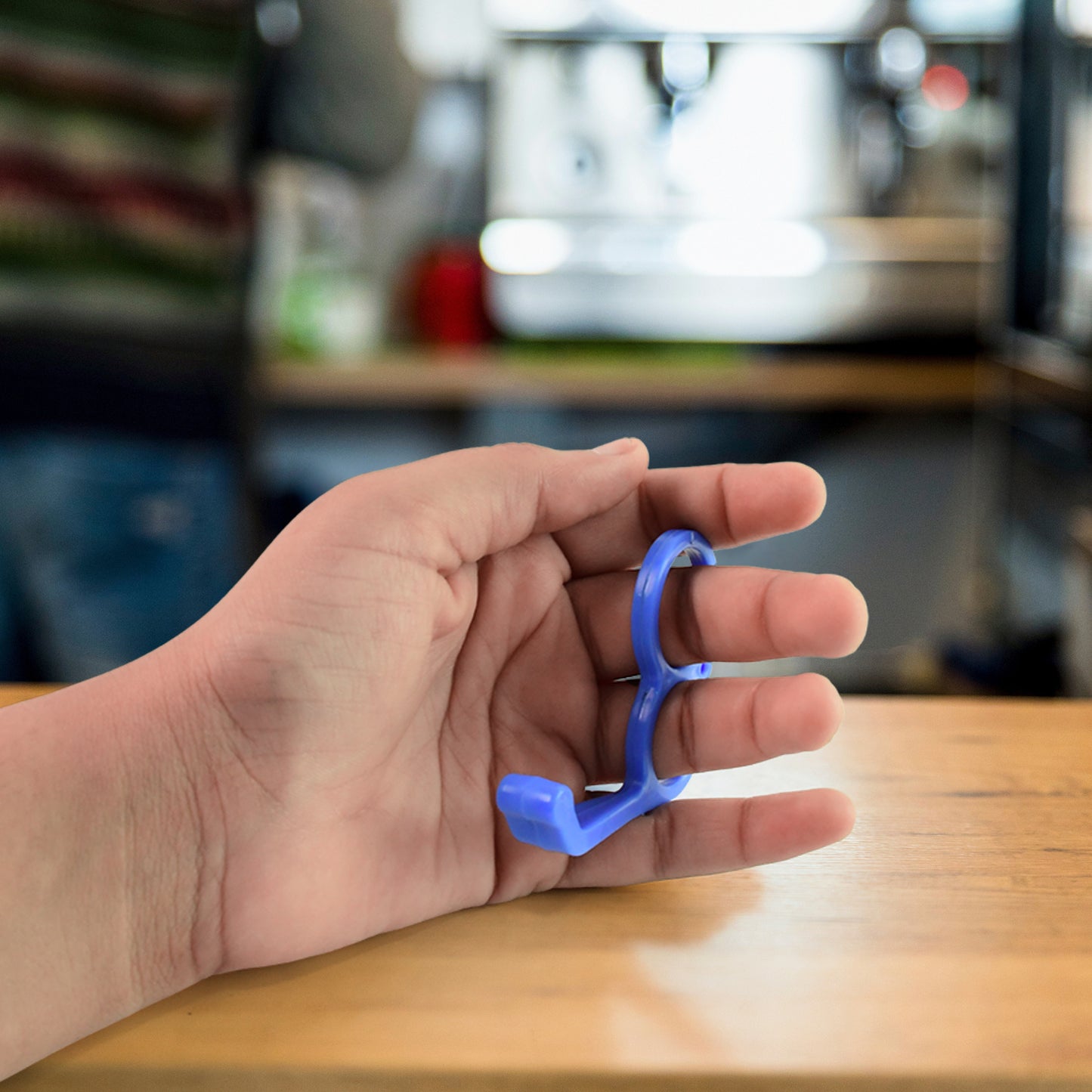 Colorful plastic hand mobile stand by Wukusy, designed to hold smartphones securely in various angles.