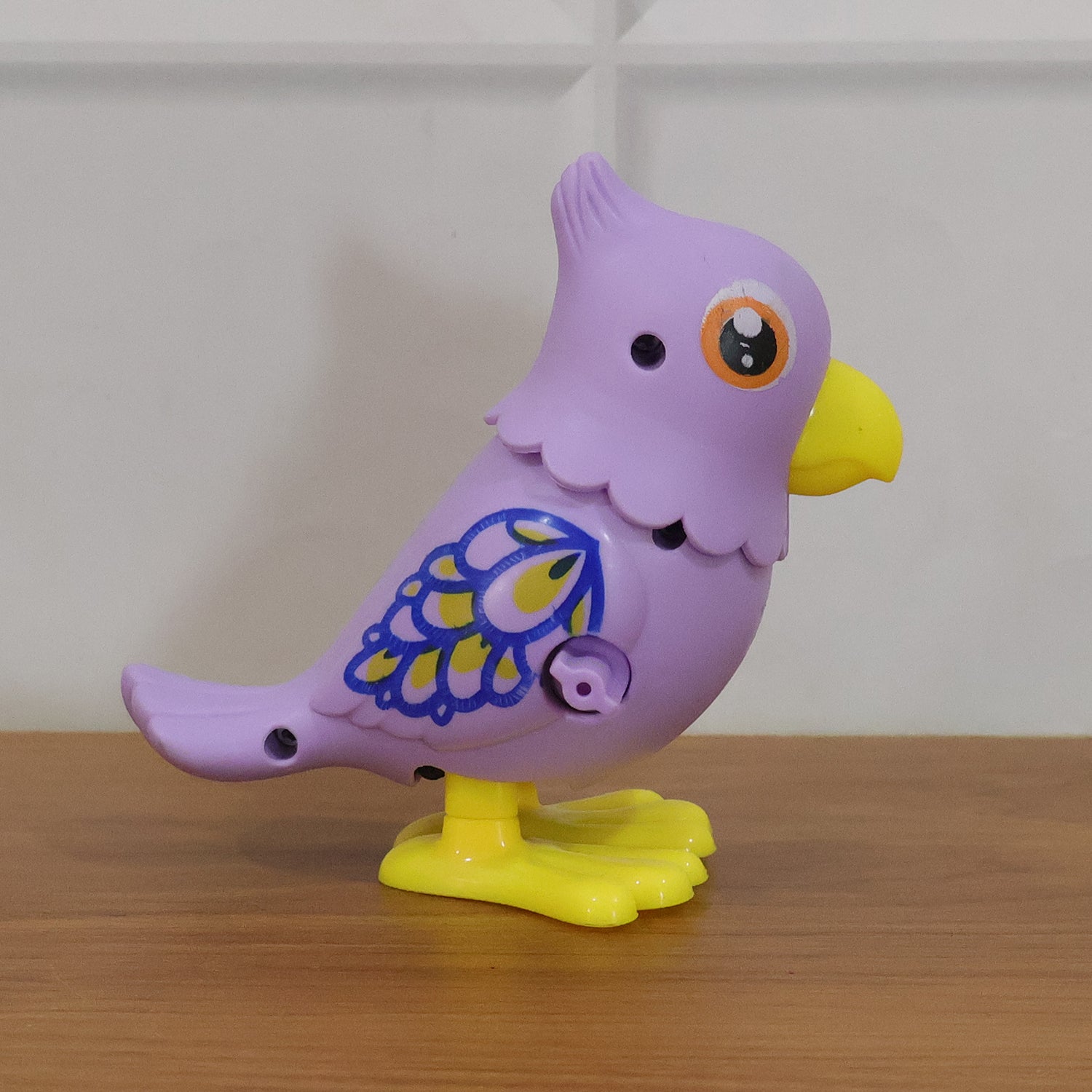 Wukusy key operated jumping bird toy for kids, colorful plastic bird with key mechanism and motion features.