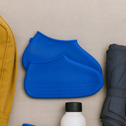 Pair of blue Wukusy waterproof silicone rain boot covers with anti-skid soles, foldable and reusable for travel protection.