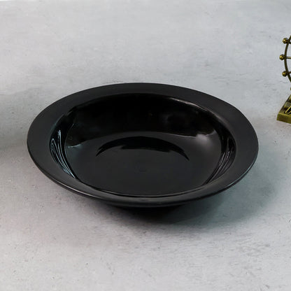 Wukusy premium deep black curry soup serving bowl with curved edges, ideal for serving soups and stews in a modern kitchen setting.