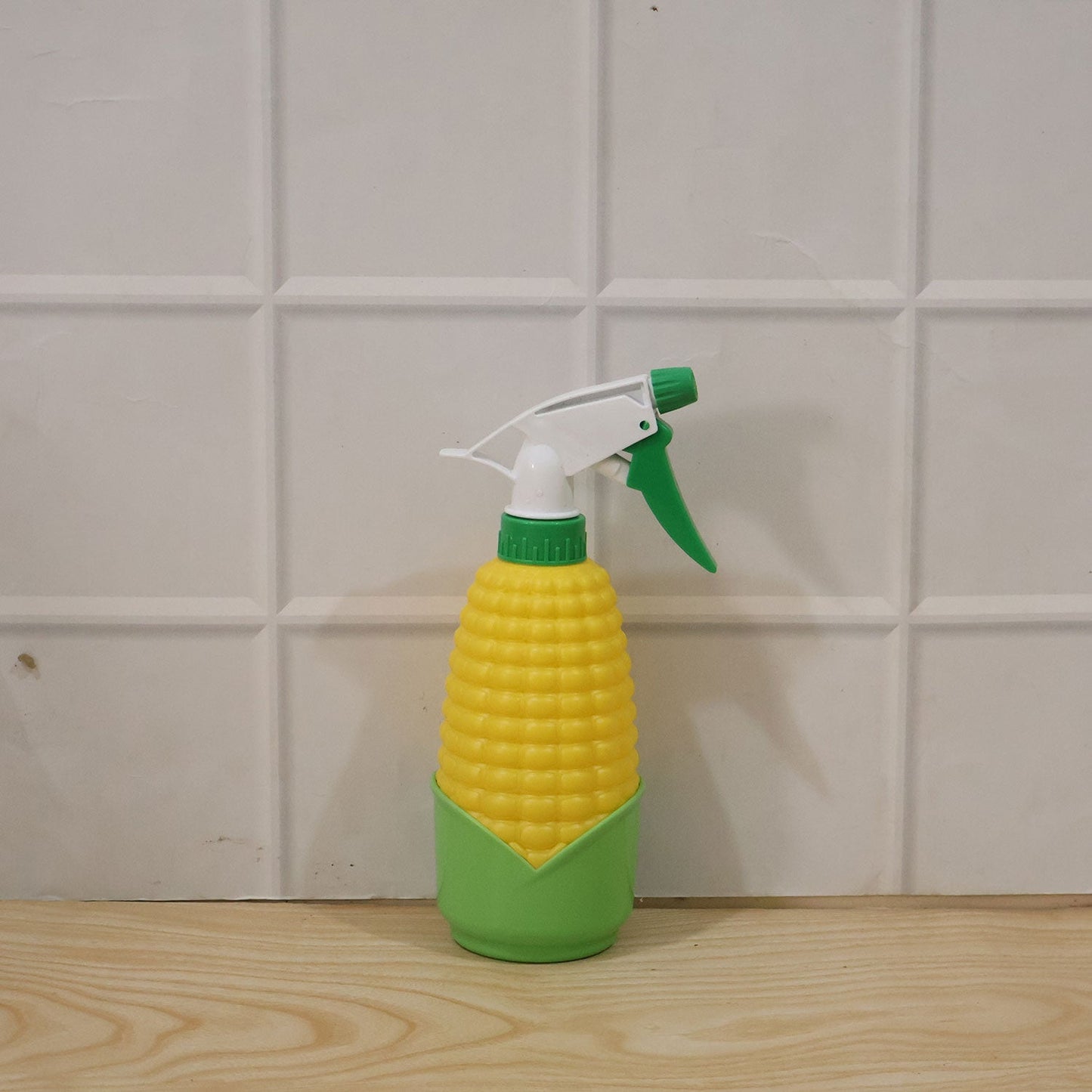 Wukusy corn-shaped trigger spray bottle for plants and cleaning, with a clear plastic container and ergonomic spray nozzle.