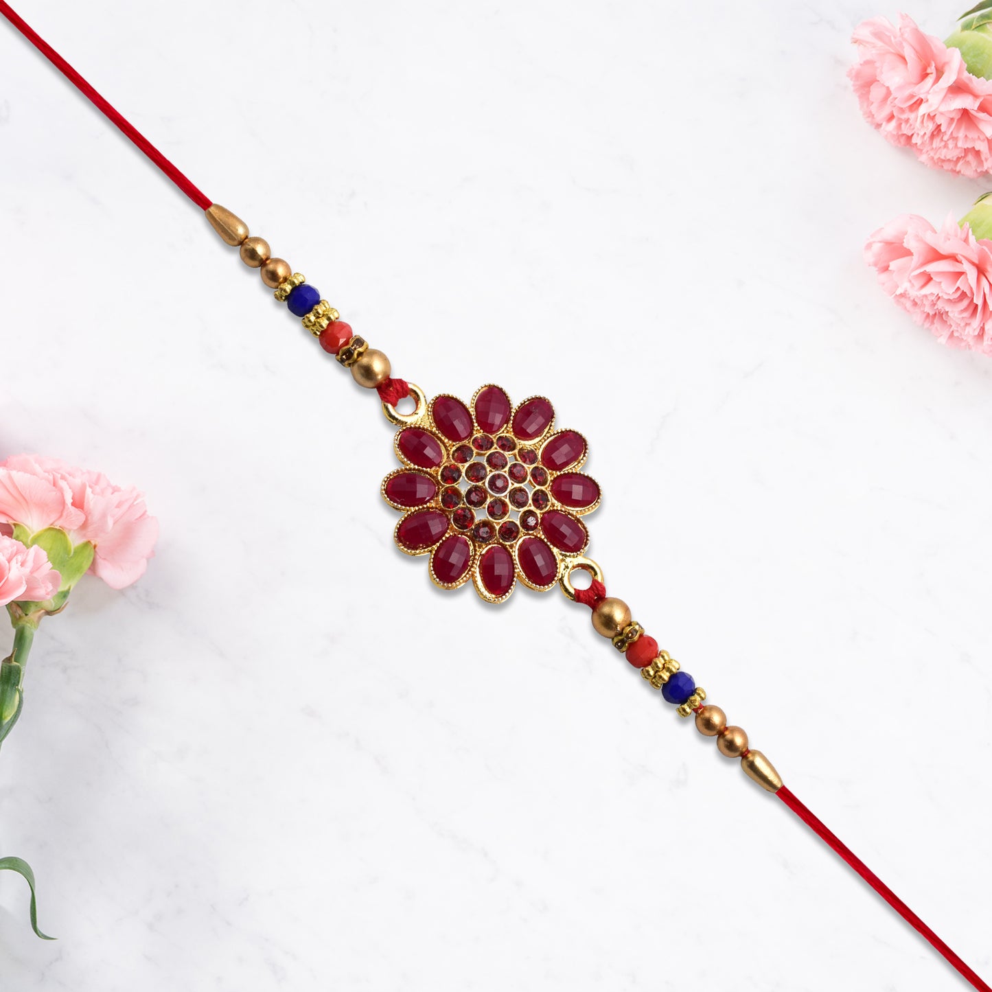 Red floral stone rakhi with bead accents, featuring intricate design and vibrant colors, by Wukusy for festive occasions.