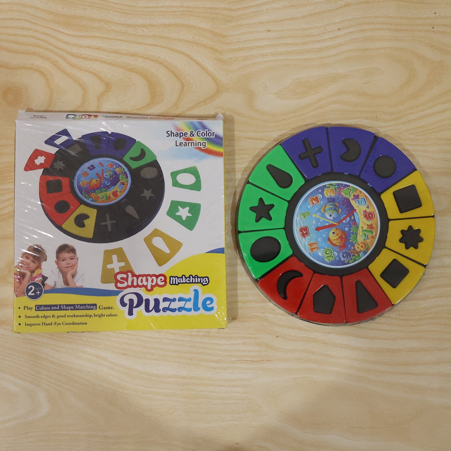 Wukusy shape and color matching puzzle toy with clock for kids and toddlers, featuring colorful interlocking pieces and clock face.