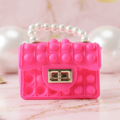 Kids Pop It fidget purse by Wukusy featuring silicone design, pearl handle, and playful style, perfect for children.