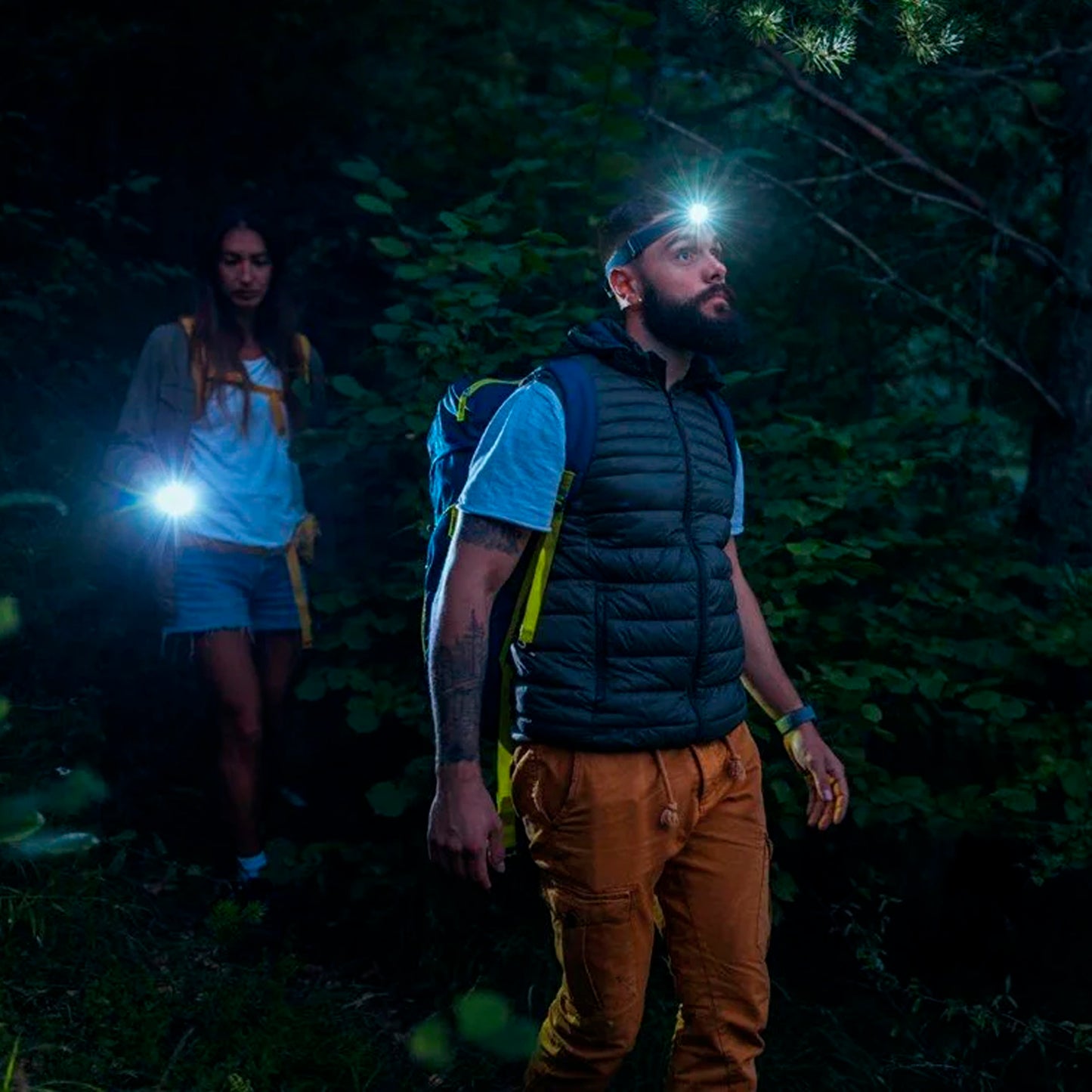 Wukusy 7517 LED head lamp with adjustable strap, rechargeable, used for camping, hiking, fishing, cycling, and outdoor activities.