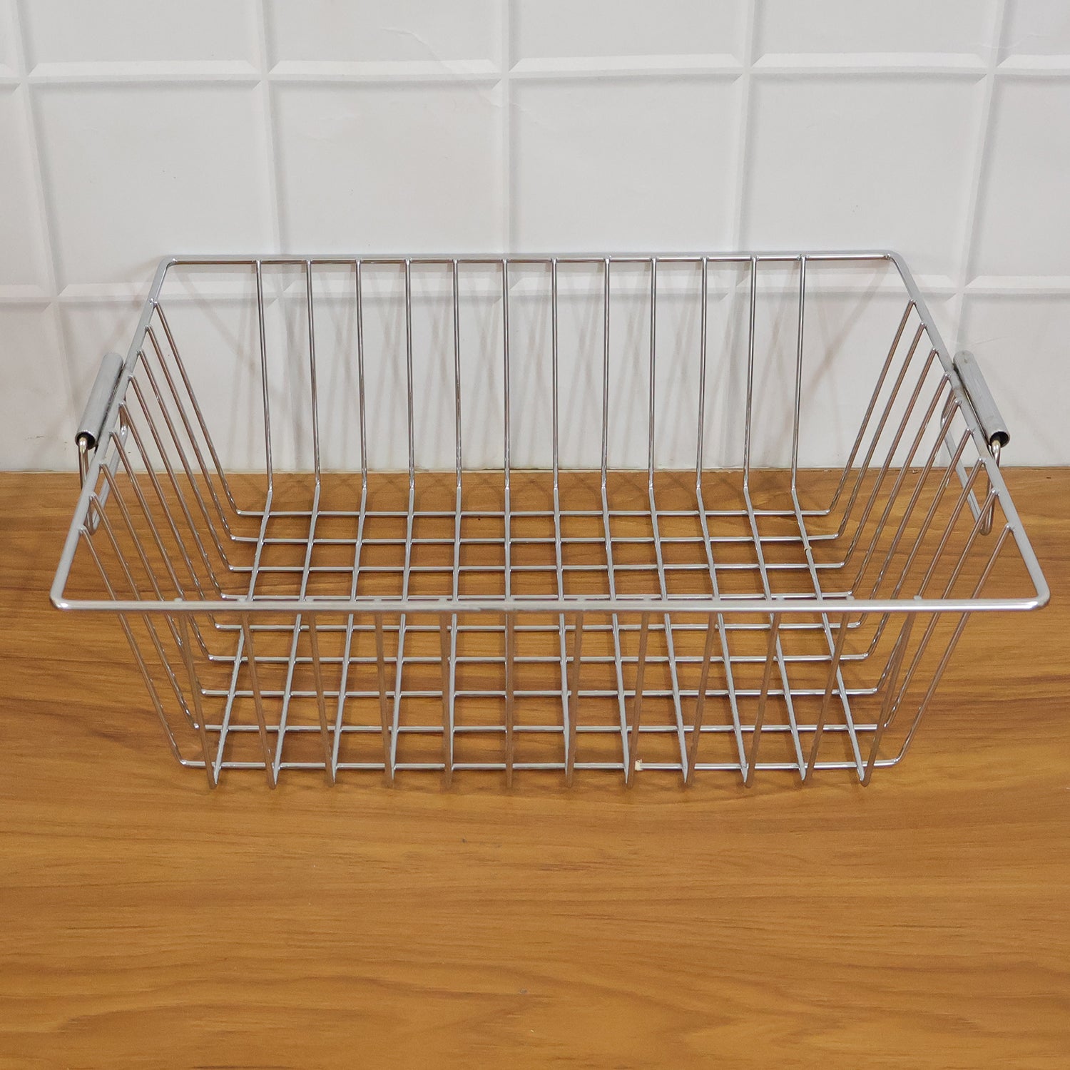 Wukusy stainless steel kitchen sink basket, 12x15 inch, used for draining and organizing utensils or produce in the sink.