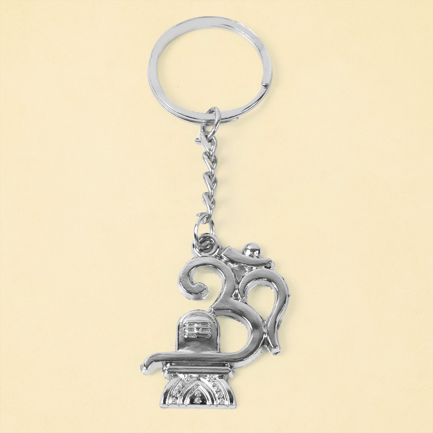 Metal keychain featuring Om and Shivling symbols, crafted by Wukusy, displayed with a detailed close-up of the design.