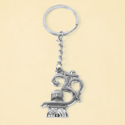 Metal keychain featuring Om and Shivling symbols, crafted by Wukusy, displayed with a detailed close-up of the design.