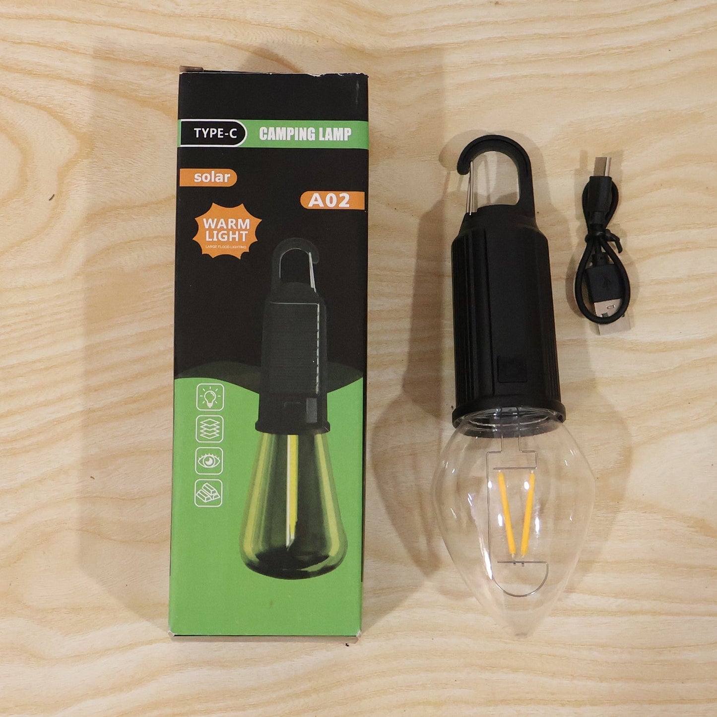 Wukusy solar rechargeable camping lamp with warm LED bulb and carabiner clip, ideal for outdoor camping and hiking.