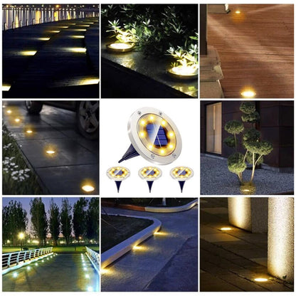 Set of four Wukusy solar-powered LED garden lights illuminating a garden pathway with warm light at dusk.
