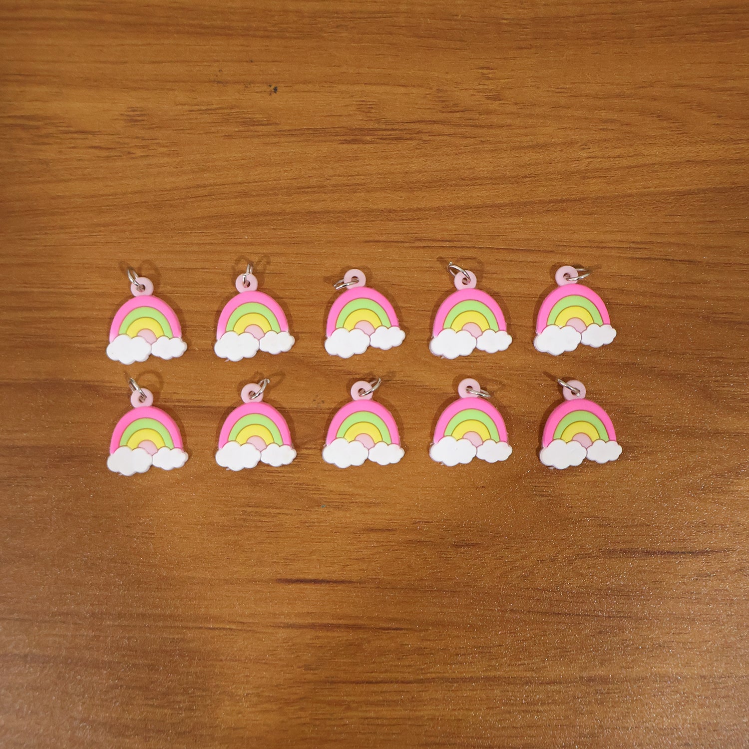 Set of 10 colorful rainbow cloud bag charm keychains by Wukusy, featuring cute cloud and rainbow designs for accessories.