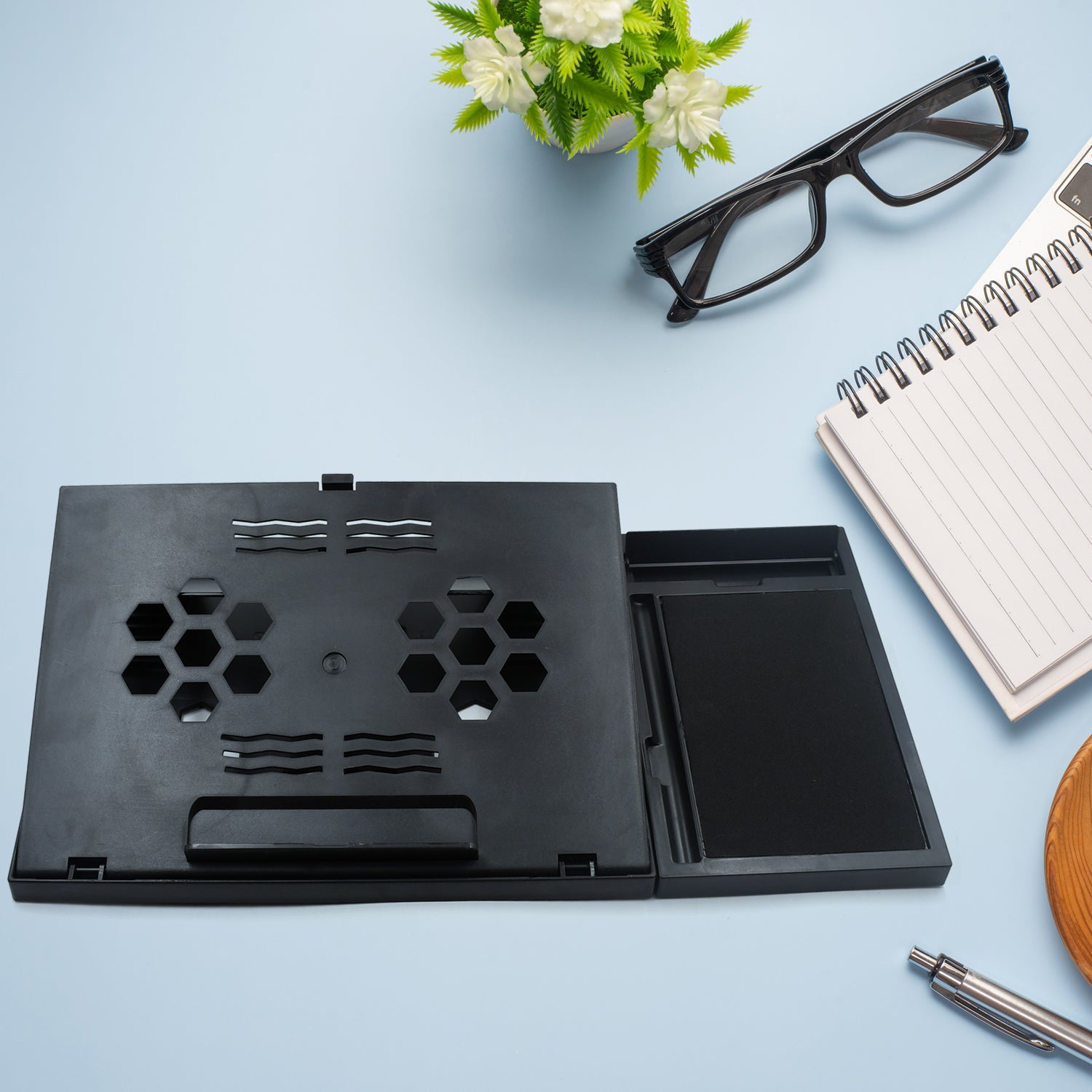 Wukusy portable foldable laptop stand with tray for MacBook, tablets, and notebooks, includes a free phone stand on a desk.