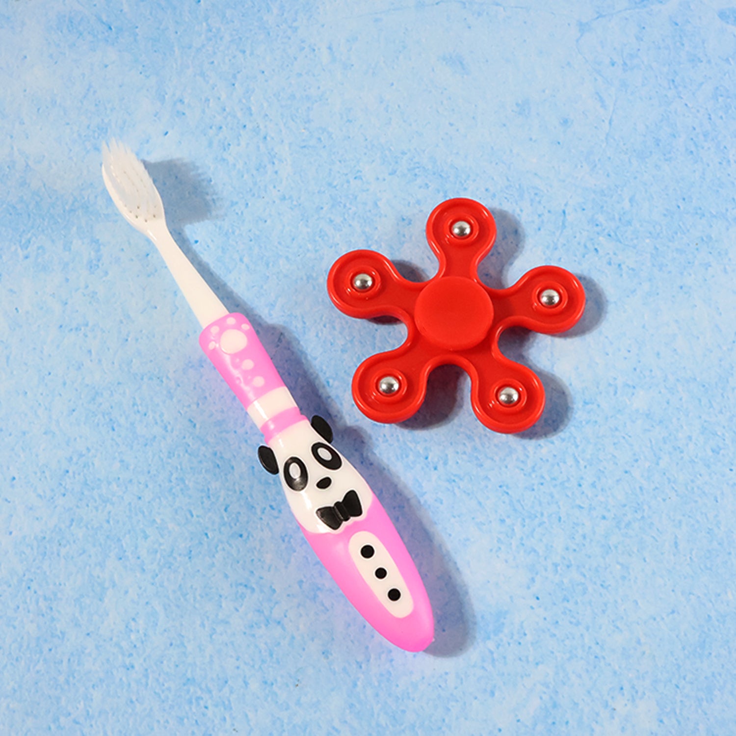 Wukusy kids toothbrush and fidget spinner toy set, colorful toothbrush with cartoon design and a blue spinning fidget toy.