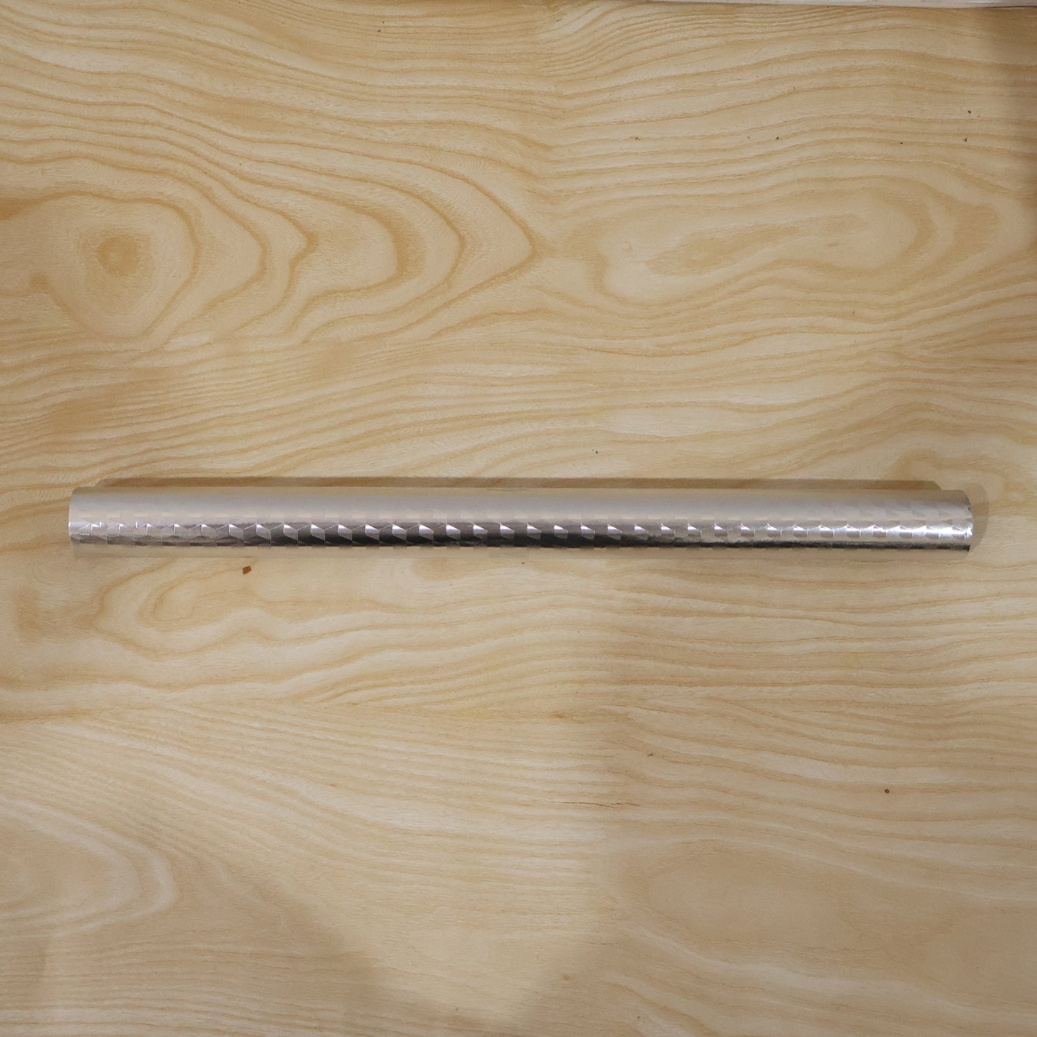 Wukusy aluminium foil paper roll for kitchen wrapping, food storage, cooking, and baking, shown unrolled on a flat surface.