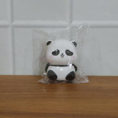 Cute mini panda night light lamp by Wukusy, showing a small panda-shaped LED night light illuminated in a cozy setting.
