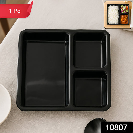 Black plastic multi-compartment meal serving tray with three sections, ideal for dining and meal presentation.