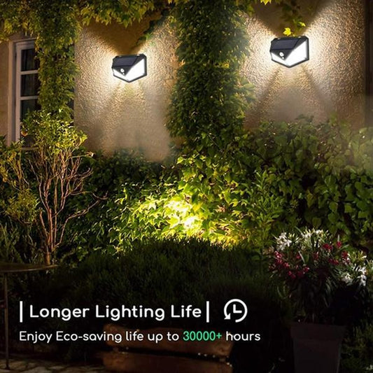 Wukusy 1255 solar garden lights with LED security lamps illuminating outdoor pathways and home exterior at night.