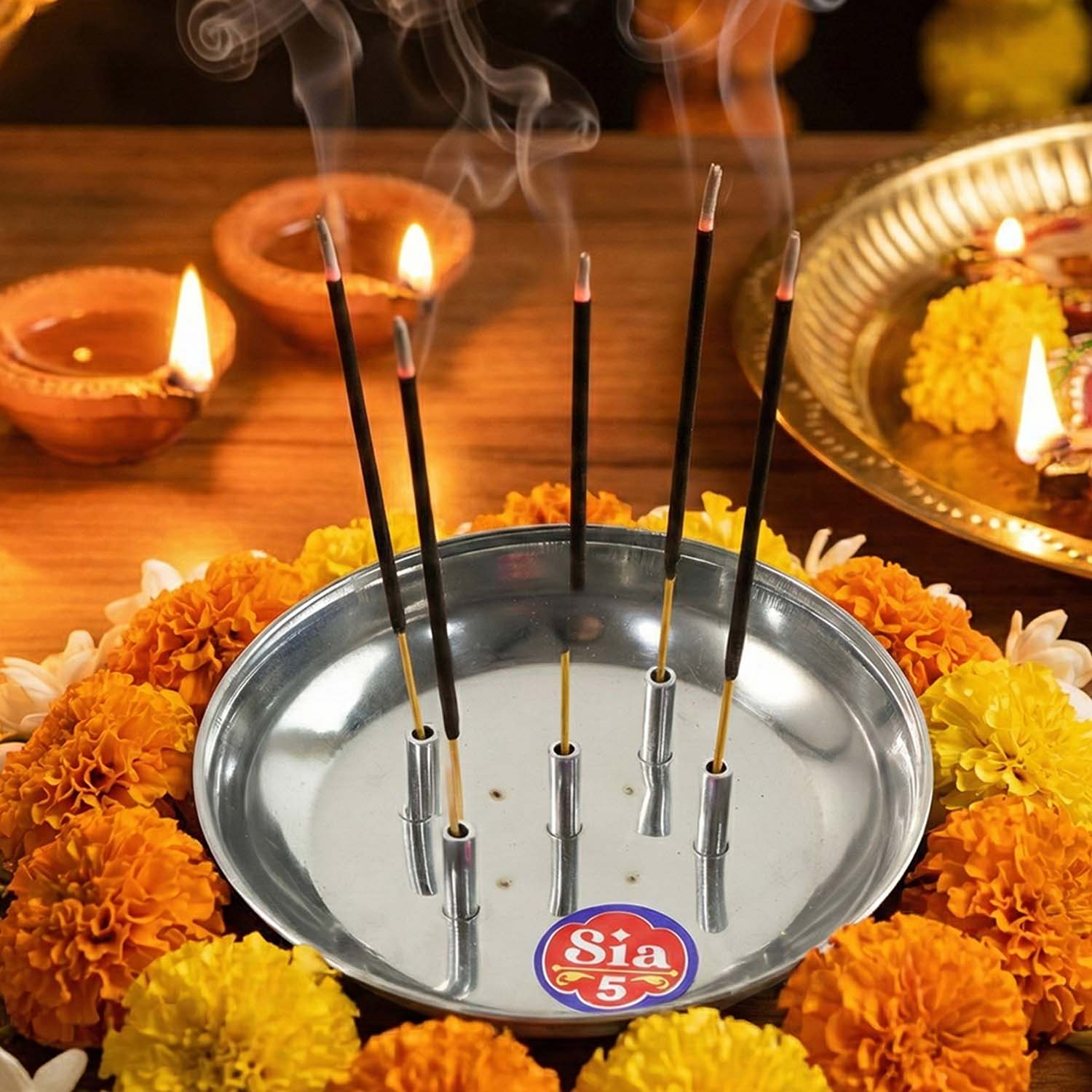 Stainless steel Agarbatti stand by Wukusy, model Sia-5, holding incense sticks, with a sleek metallic finish and minimalist design.