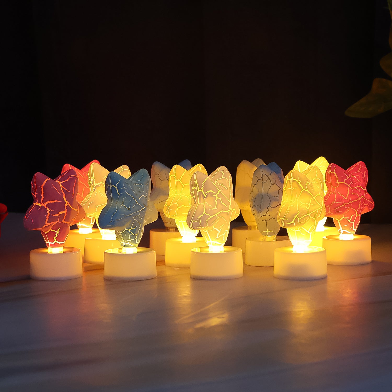 Set of 12 Wukusy star-shaped decorative LED tealight candles for home decor, featuring glowing star designs in a warm light.