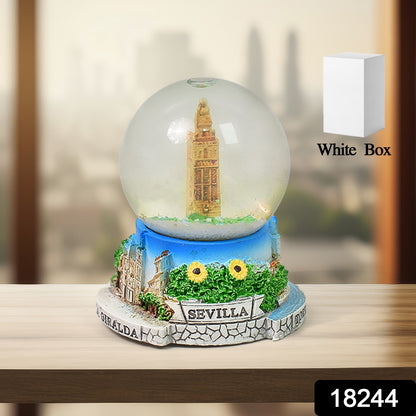 Wukusy snow globe souvenir on a desk, featuring a winter scene with miniature figures, ideal for office decoration.