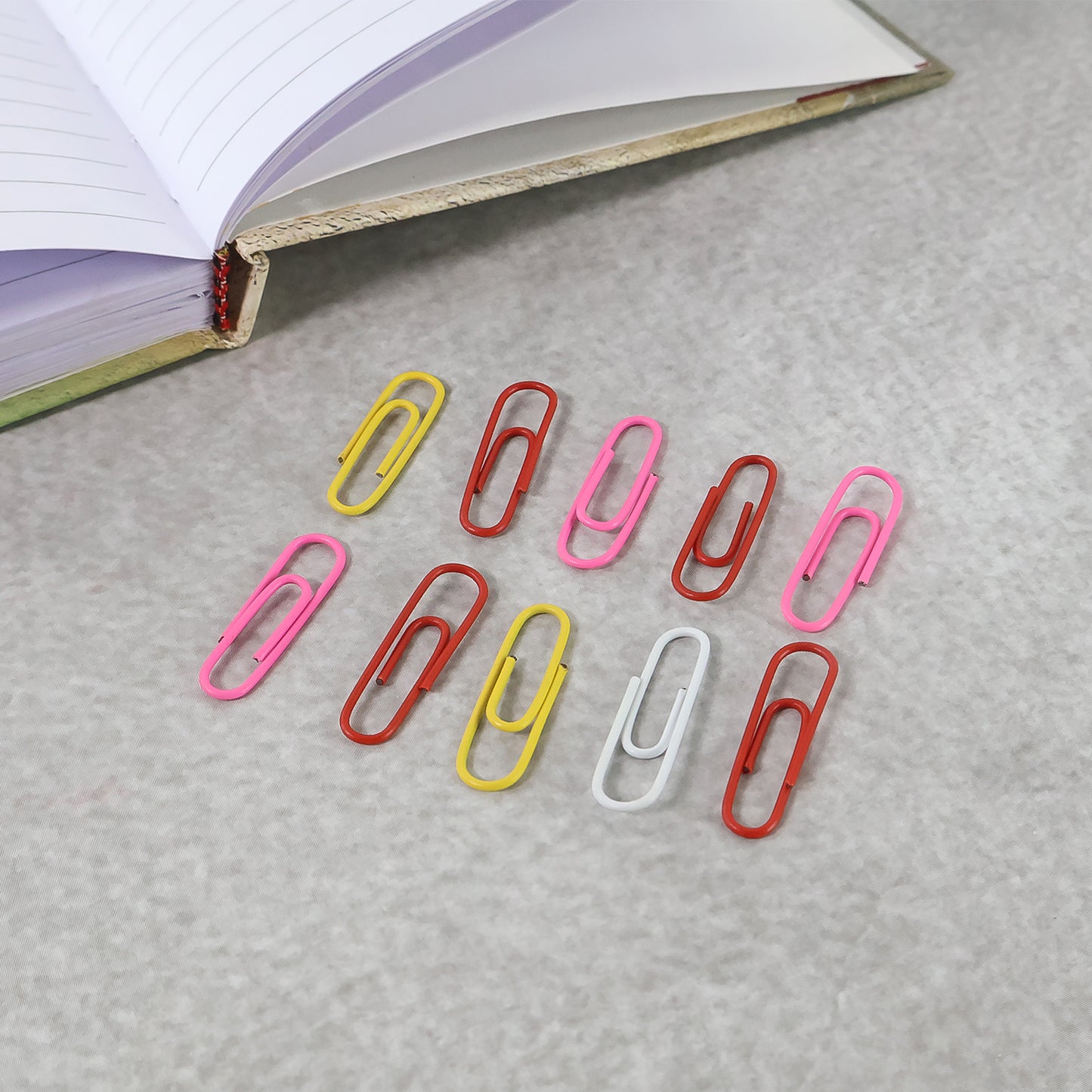 Set of 10 vinyl-coated paper clips in a Wukusy office supply set, featuring colorful, durable metal clips for organizing papers.