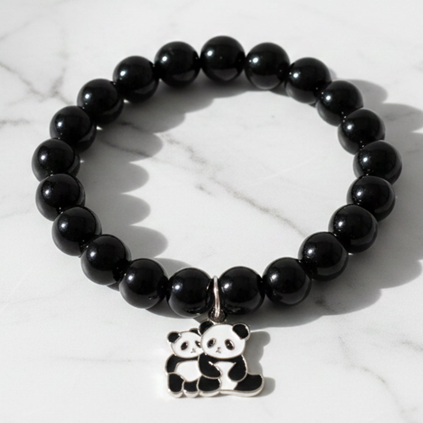 Black beaded stretch bracelet by Wukusy with a cute panda charm, featuring elastic design for comfortable wear.