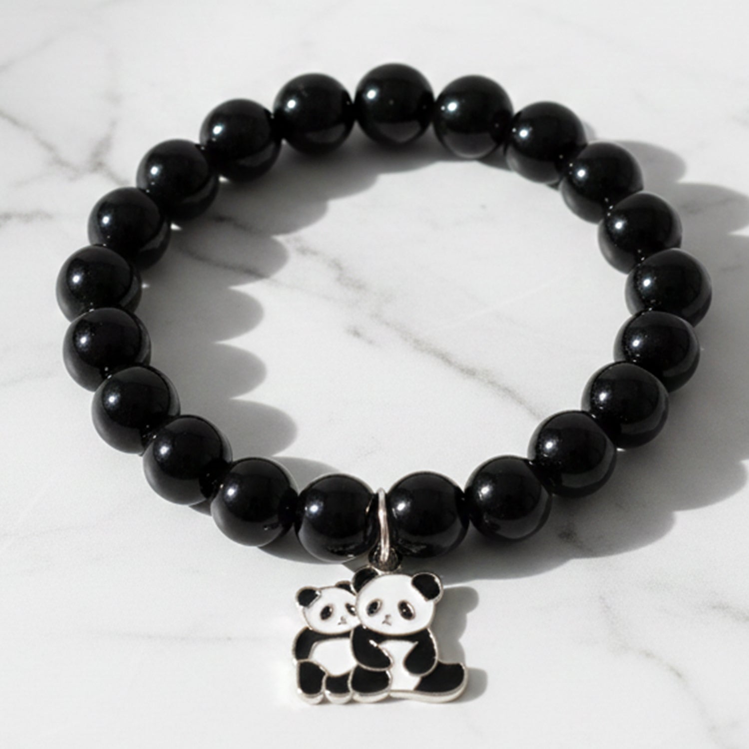 Black beaded stretch bracelet by Wukusy with a cute panda charm, featuring elastic design for comfortable wear.