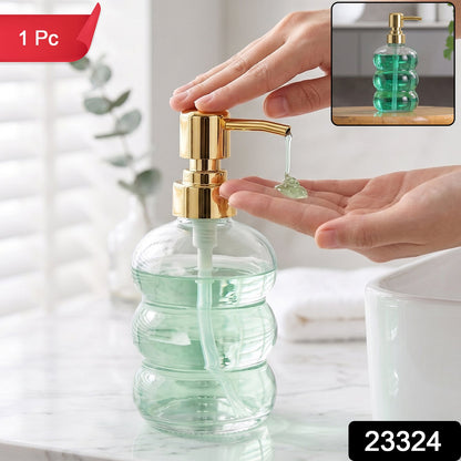Transparent glass liquid soap dispenser bottle with a gold pump, featuring a sleek and modern design by Wukusy.
