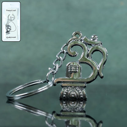 Wukusy metal keychain featuring Om symbol with Shivling design, showcasing intricate details and polished finish.