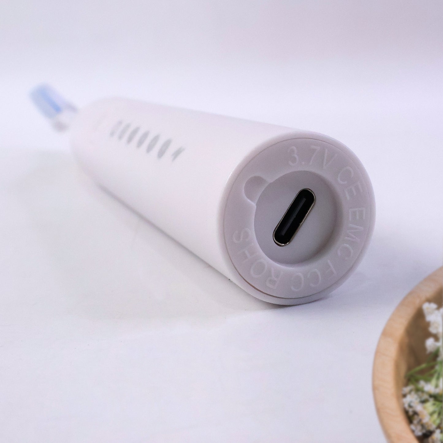 Wukusy rechargeable electric toothbrush in white with three extra brush heads, showing the toothbrush and replacement heads.
